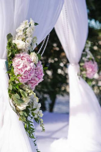 Wedding arch of the bride and groom decorated with flowers of roses